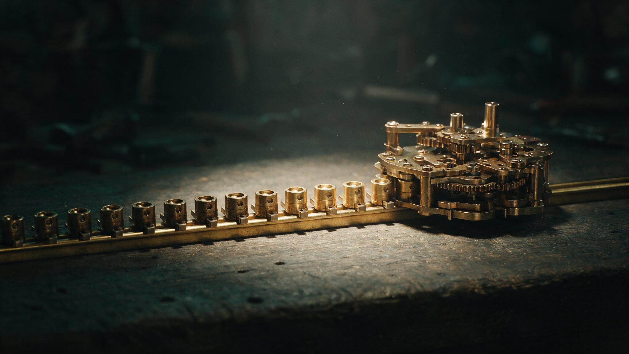 Small identical components arriving one at a time along a brass track and seating themselves into a mechanism that has grown by accretion, with nobody present
